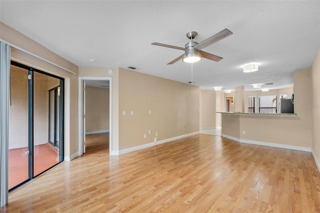 7449 Sugar Bend Dr Unit 7449, Orlando, FL 32819 - unfurnished living room featuring light wood-style flooring, ceiling fan, and baseboards