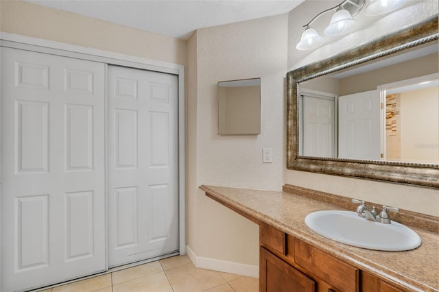 7449 Sugar Bend Dr Unit 7449, Orlando, FL 32819 - bathroom with tile patterned flooring, vanity, and baseboards