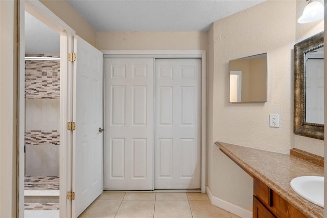 7449 Sugar Bend Dr Unit 7449, Orlando, FL 32819 - full bath featuring a tile shower, tile patterned flooring, vanity, and baseboards
