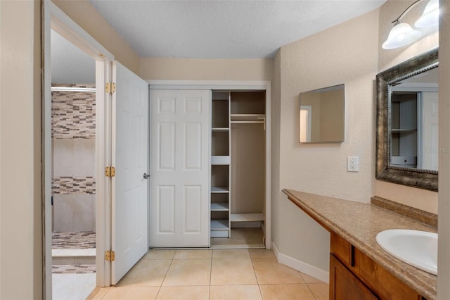 7449 Sugar Bend Dr Unit 7449, Orlando, FL 32819 - bathroom with a stall shower, tile patterned flooring, vanity, and baseboards