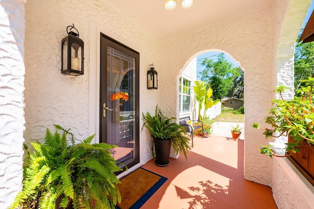 doorway to property featuring stucco siding