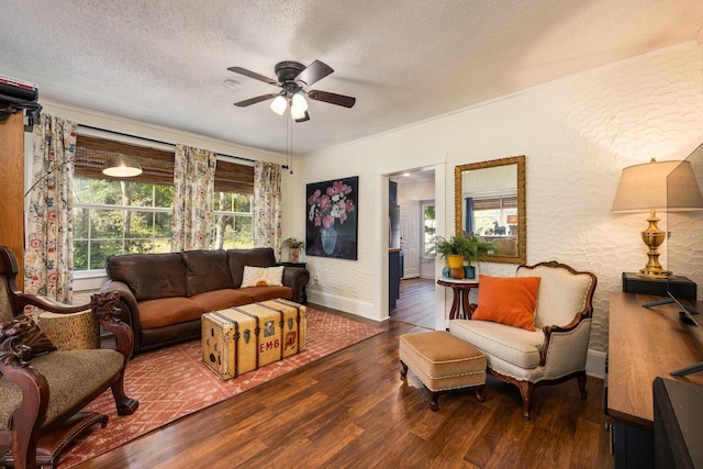 living room featuring wood finished floors, a ceiling fan, a textured ceiling, baseboards, and a textured wall