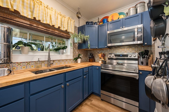 kitchen with blue cabinets, wooden counters, and appliances with stainless steel finishes