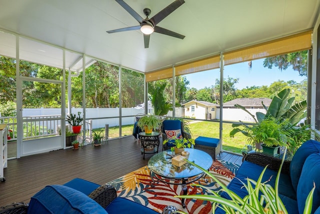 sunroom / solarium with ceiling fan and an outdoor living space