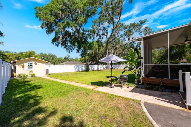 view of yard featuring a sunroom, a patio, and a fenced backyard