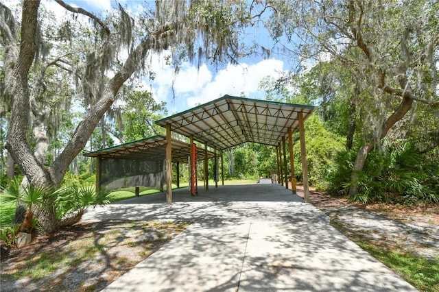 surrounding community featuring driveway and a detached carport