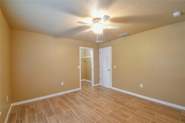 spare room featuring ceiling fan, visible vents, baseboards, and light wood-style floors
