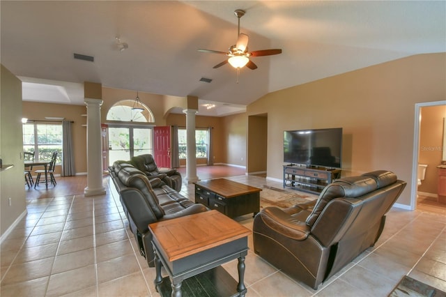 living room with ceiling fan, baseboards, decorative columns, vaulted ceiling, and visible vents
