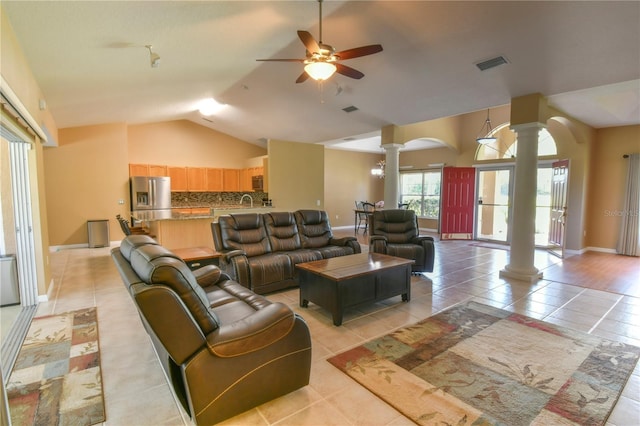 living room with visible vents, decorative columns, lofted ceiling, arched walkways, and a ceiling fan