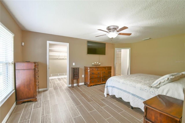 bedroom featuring a ceiling fan, baseboards, visible vents, and light wood-style floors