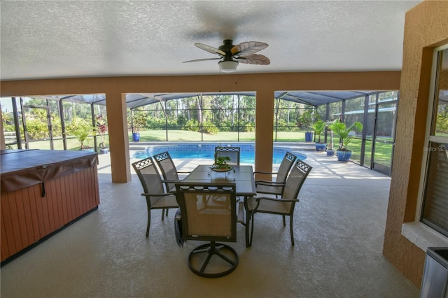 sunroom featuring a swimming pool, a ceiling fan, and a hot tub