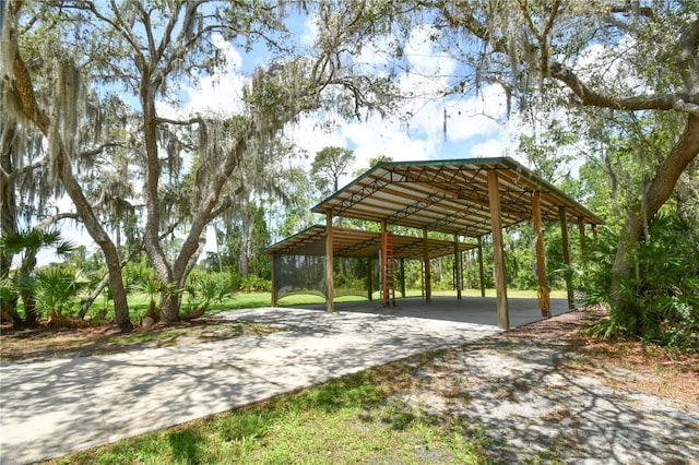 view of community featuring driveway and a carport