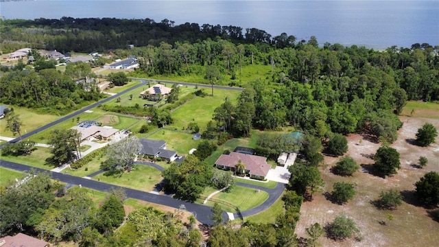 aerial view featuring a water view and a wooded view
