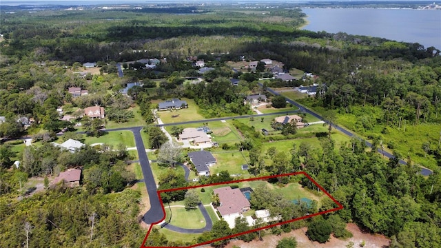 aerial view featuring a water view and a forest view