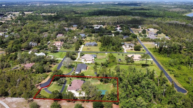birds eye view of property featuring a residential view and a forest view