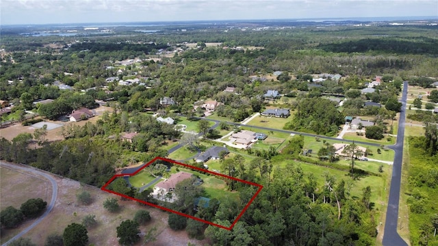 drone / aerial view featuring a view of trees and a residential view