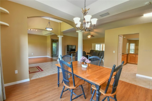 dining space with visible vents, arched walkways, baseboards, light wood finished floors, and ornate columns
