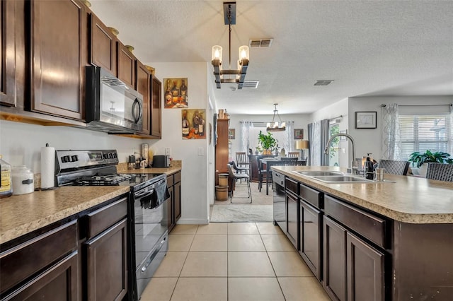 822 Sheen Cir, Haines City, FL 33844 - kitchen with an inviting chandelier, a sink, a textured ceiling, black range with electric cooktop, and visible vents