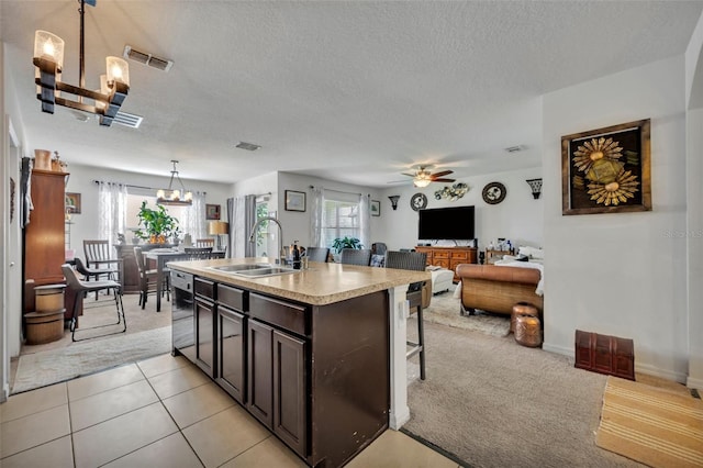 822 Sheen Cir, Haines City, FL 33844 - kitchen with dark brown cabinets, dishwashing machine, a textured ceiling, a sink, and ceiling fan with notable chandelier