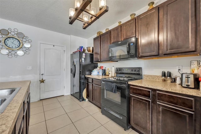 822 Sheen Cir, Haines City, FL 33844 - kitchen with light countertops, dark brown cabinets, light tile patterned floors, and black appliances