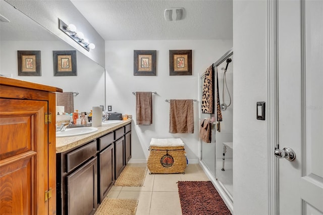 822 Sheen Cir, Haines City, FL 33844 - full bath featuring a sink, tile patterned flooring, double vanity, a textured ceiling, and a shower stall