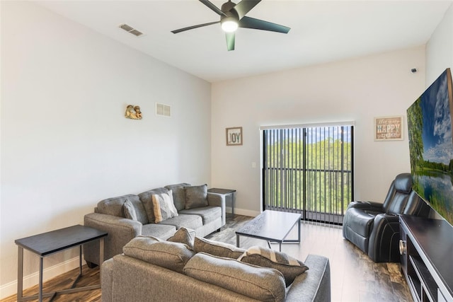 living room with a ceiling fan, wood finished floors, and baseboards