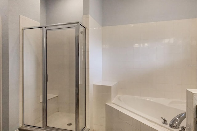 full bath with a stall shower and a bath