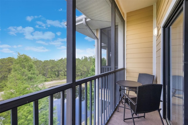 balcony featuring a forest view