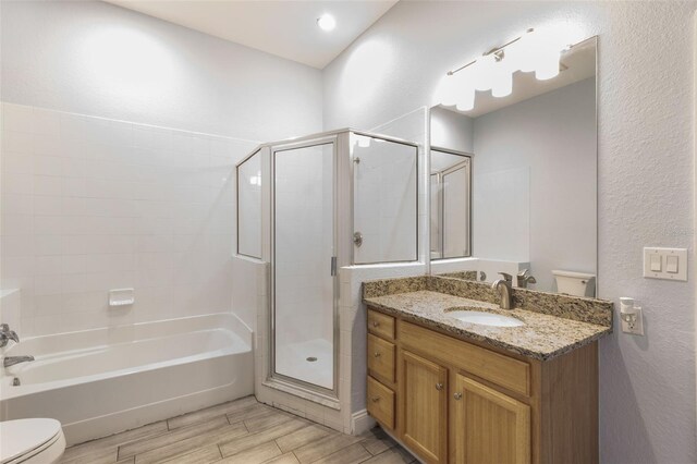 bathroom with toilet, a shower with shower door, wood finished floors, a tub, and a textured wall