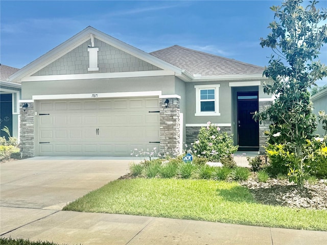 7871 Penrose Pl, Wildwood, FL 34785 - craftsman-style house featuring roof with shingles, a garage, concrete driveway, stone siding, and stucco siding