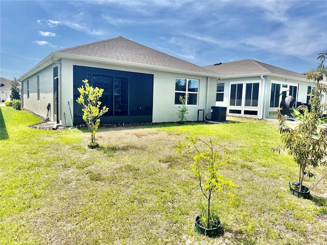 7871 Penrose Pl, Wildwood, FL 34785 - back of house featuring central AC unit, stucco siding, and a yard
