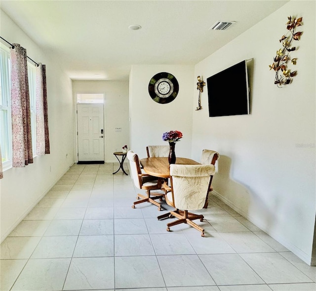 7871 Penrose Pl, Wildwood, FL 34785 - dining area featuring light tile patterned floors and visible vents