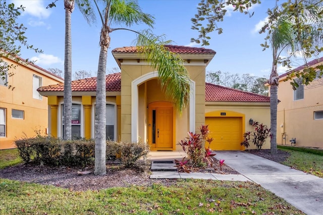1031 Marcello Blvd, Kissimmee, FL 34746 - mediterranean / spanish-style home with a tiled roof, stucco siding, concrete driveway, and a garage