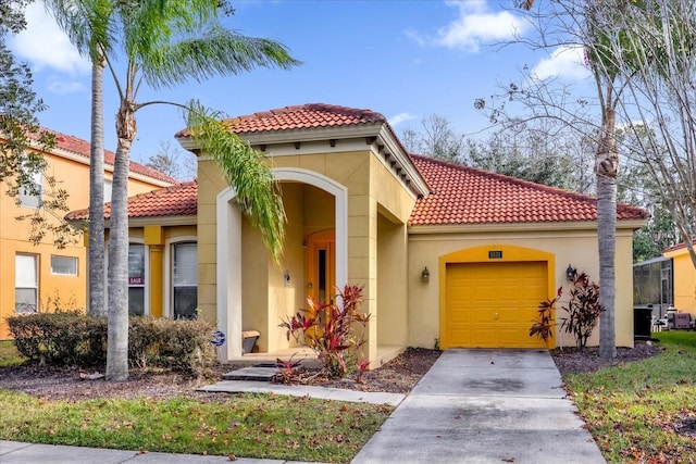 1031 Marcello Blvd, Kissimmee, FL 34746 - mediterranean / spanish house with a garage, stucco siding, a tiled roof, and driveway