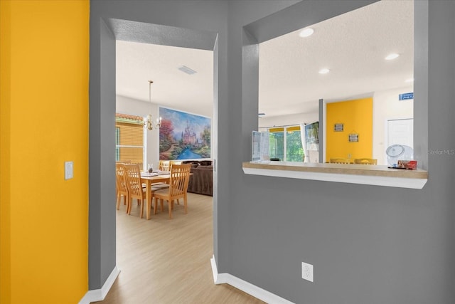 1031 Marcello Blvd, Kissimmee, FL 34746 - corridor featuring a textured ceiling, a chandelier, recessed lighting, baseboards, and wood finished floors
