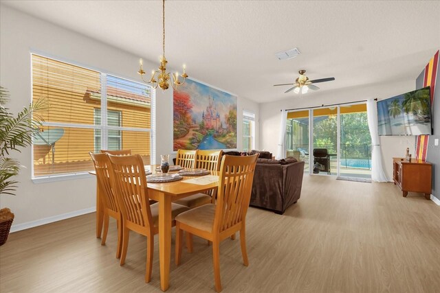 1031 Marcello Blvd, Kissimmee, FL 34746 - dining area featuring light wood-style floors, baseboards, ceiling fan with notable chandelier, and visible vents