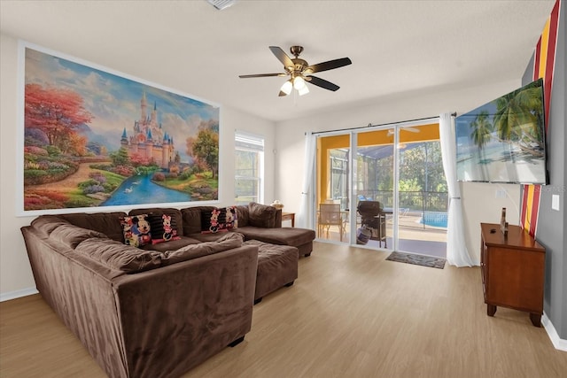 1031 Marcello Blvd, Kissimmee, FL 34746 - living area with baseboards, a ceiling fan, and light wood finished floors