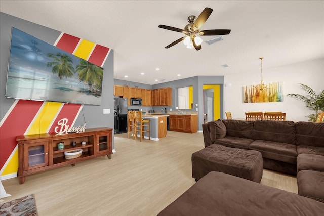 1031 Marcello Blvd, Kissimmee, FL 34746 - living room with visible vents, baseboards, ceiling fan with notable chandelier, recessed lighting, and light wood-style flooring
