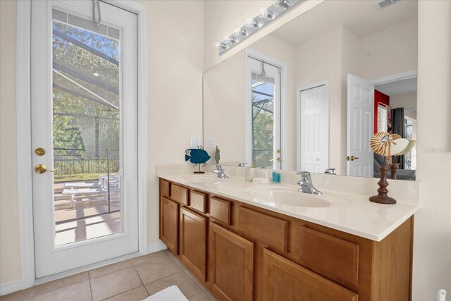 1031 Marcello Blvd, Kissimmee, FL 34746 - bathroom with baseboards, double vanity, tile patterned floors, and a sink