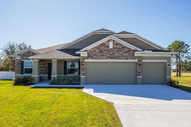 6179 Notre Dame Ter, North Port, FL 34291 - craftsman-style house featuring a garage, driveway, a front yard, stone siding, and stucco siding