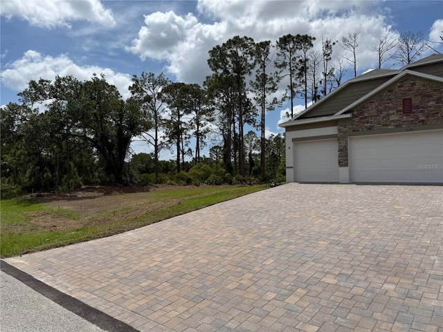6179 Notre Dame Ter, North Port, FL 34291 - garage featuring decorative driveway