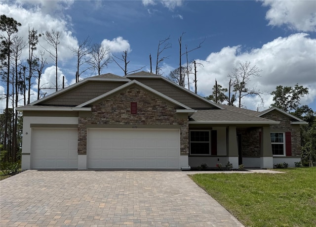 6179 Notre Dame Ter, North Port, FL 34291 - view of front facade with decorative driveway, a front yard, a garage, and stucco siding