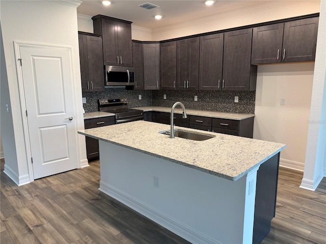 6179 Notre Dame Ter, North Port, FL 34291 - kitchen with stainless steel appliances, dark brown cabinets, tasteful backsplash, dark wood finished floors, and crown molding