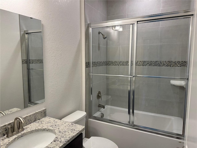 6179 Notre Dame Ter, North Port, FL 34291 - bathroom featuring a textured wall, vanity, and bath / shower combo with glass door