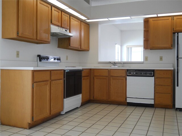kitchen with brown cabinetry, open shelves, white appliances, light countertops, and under cabinet range hood