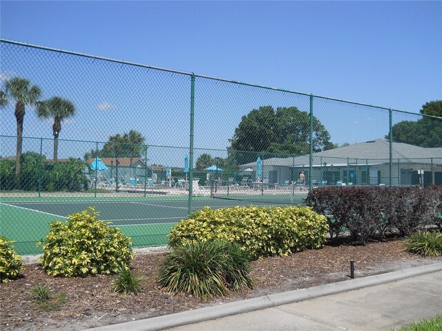 view of sport court featuring fence