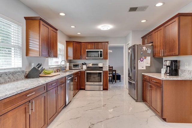 2803 Tech Dr, Orlando, FL 32817 - kitchen featuring visible vents, light stone countertops, marble finish floor, stainless steel appliances, and recessed lighting