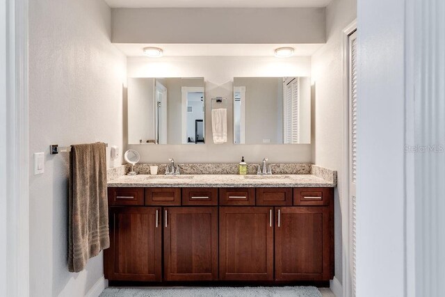 2803 Tech Dr, Orlando, FL 32817 - full bath featuring baseboards, a sink, and double vanity