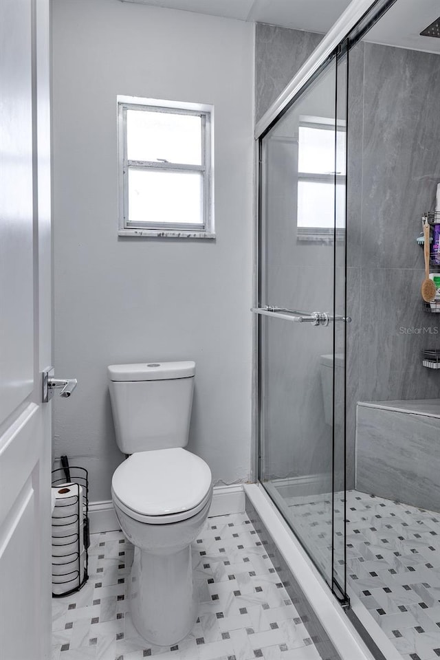 2803 Tech Dr, Orlando, FL 32817 - bathroom with baseboards, a shower stall, and toilet