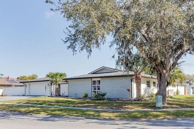 2803 Tech Dr, Orlando, FL 32817 - ranch-style home featuring a garage, a front lawn, fence, and concrete driveway